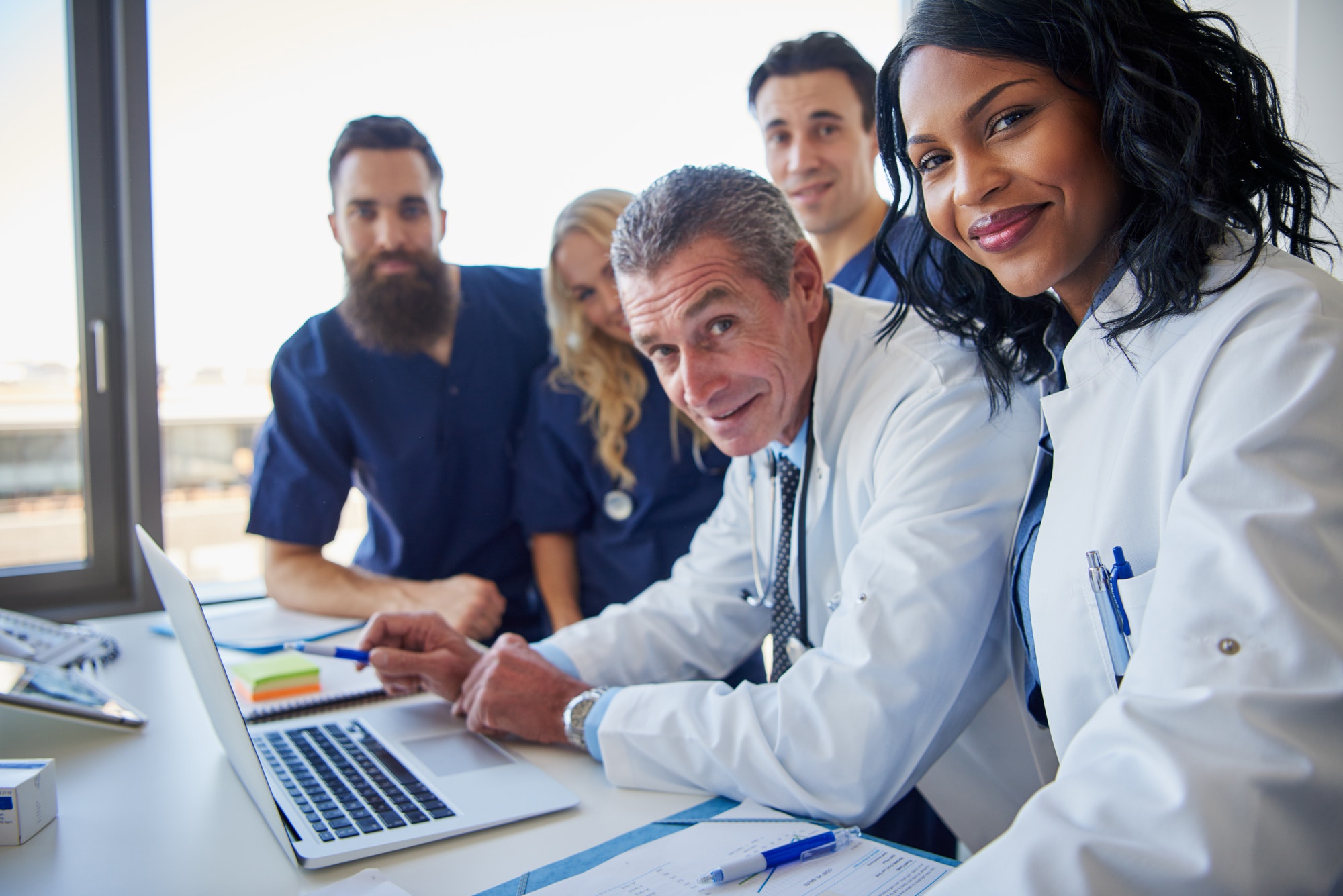 The medics looking at camera at laptop